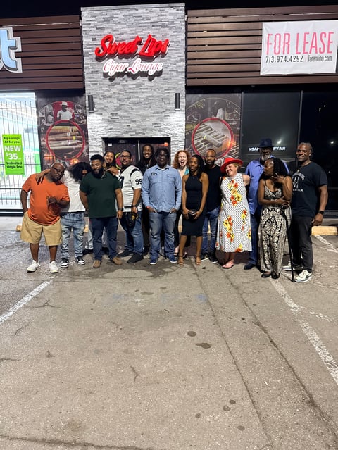 Group of people standing outside a storefront with Slow Up sign and FOR LEASE notice